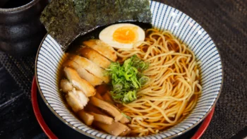 Miojo coreano do tipo lámen com frango, ovo, massa e alga.